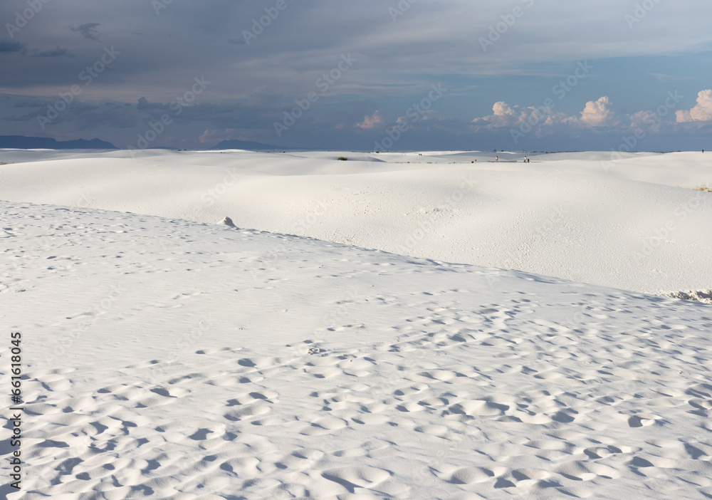 The Beautiful White Sands National Monument and Park in White Sands, New Mexico, near Alamogordo and Las Cruces, surrounded by threatening clouds in the late afternoon The Beautiful White Sands National Monument and Park in White Sands, New Mexico, near Alamogordo and Las Cruces, surrounded by threatening clouds in the late afternoon