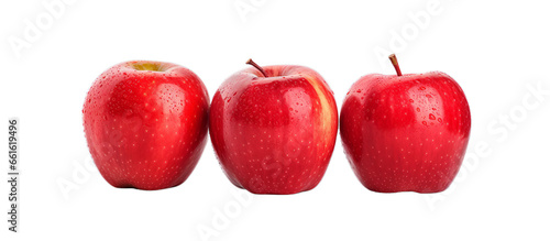 Three ripe red apples side by side