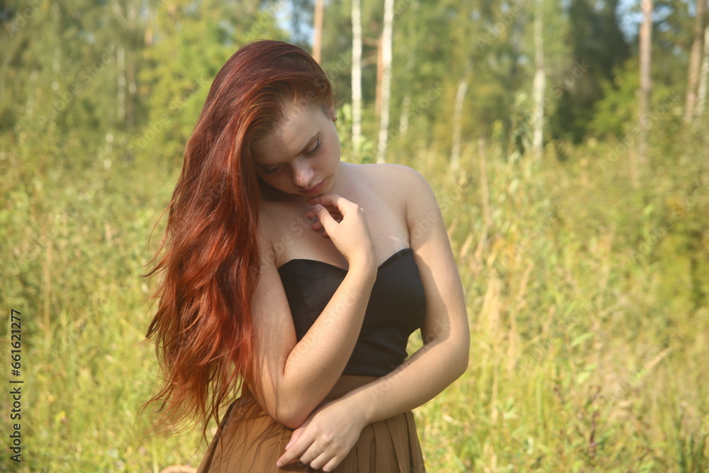 portrait of a pretty red head woman in a field portrait of a pretty red head woman in a field