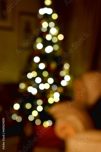 Bokeh lights of Christmas tree background at home. Defocused Christmas tree lights.