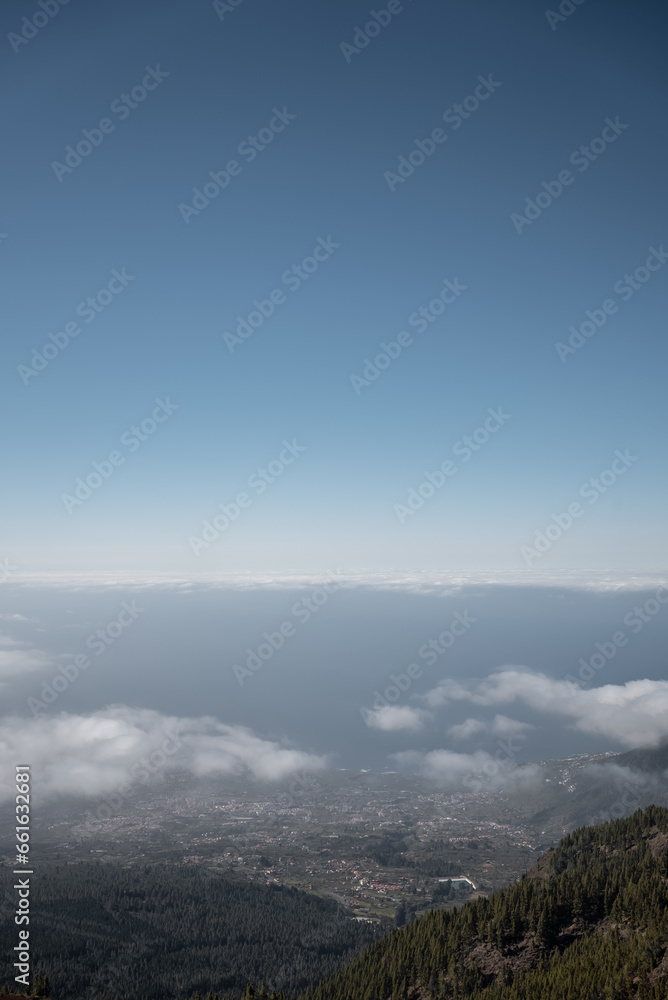 high mountain and green forest over clouds, cloudscape, Tenerife, Canary island