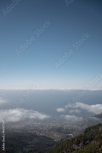 high mountain and green forest over clouds, cloudscape, Tenerife, Canary island