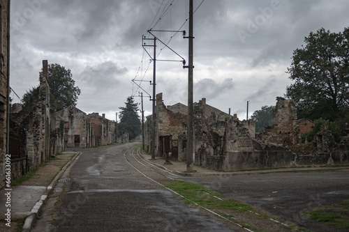 Dramatic and grayish view of the remains of the town destroyed during the war, main street, railway tracks and demolished house facades