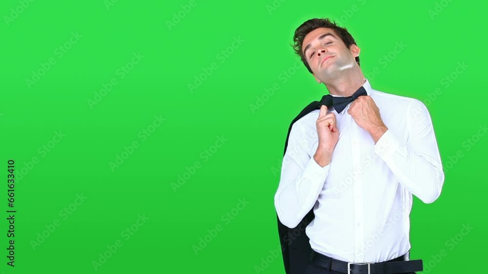 man, suit and green screen with fashion, style and confidence for clothes marketing on studio background. Face, model or person in formal shirt, bowtie and event or luxury and walking on mockup space man, suit and green screen with fashion, style and confidence for clothes marketing on studio background. Face, model or person in formal shirt, bowtie and event or luxury and walking on mockup space