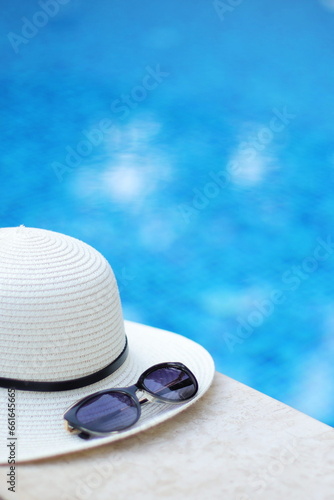 Summer hat and sunglasses in the pool. Rest, relaxation and vacation