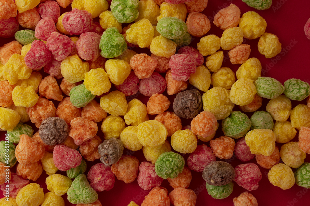 colorful cereal candies on red background colorful cereal candies on red background