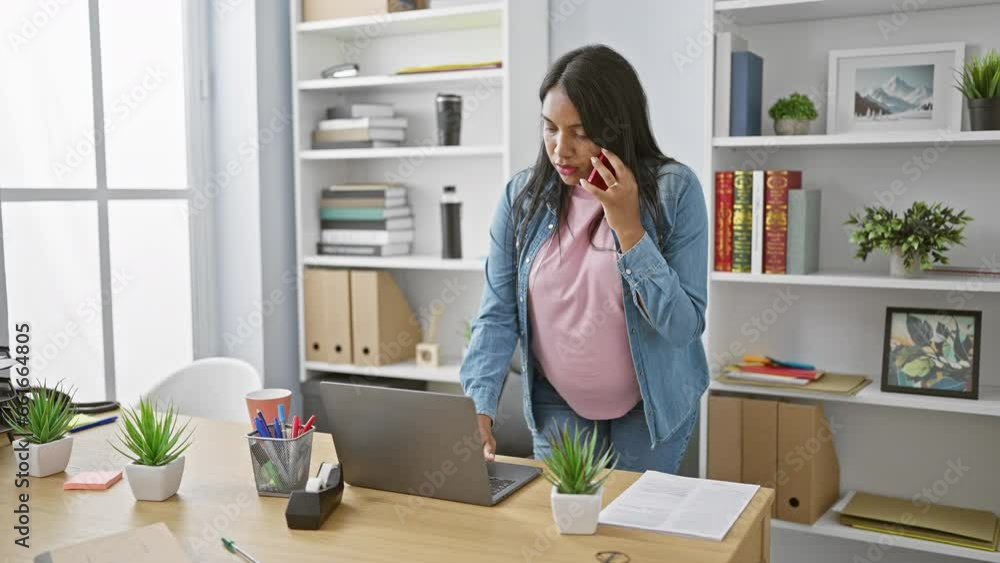 Expecting young woman worker bossing business, relaxed at the office, talking on smartphone, laptop within reach. Expecting young woman worker bossing business, relaxed at the office, talking on smartphone, laptop within reach.