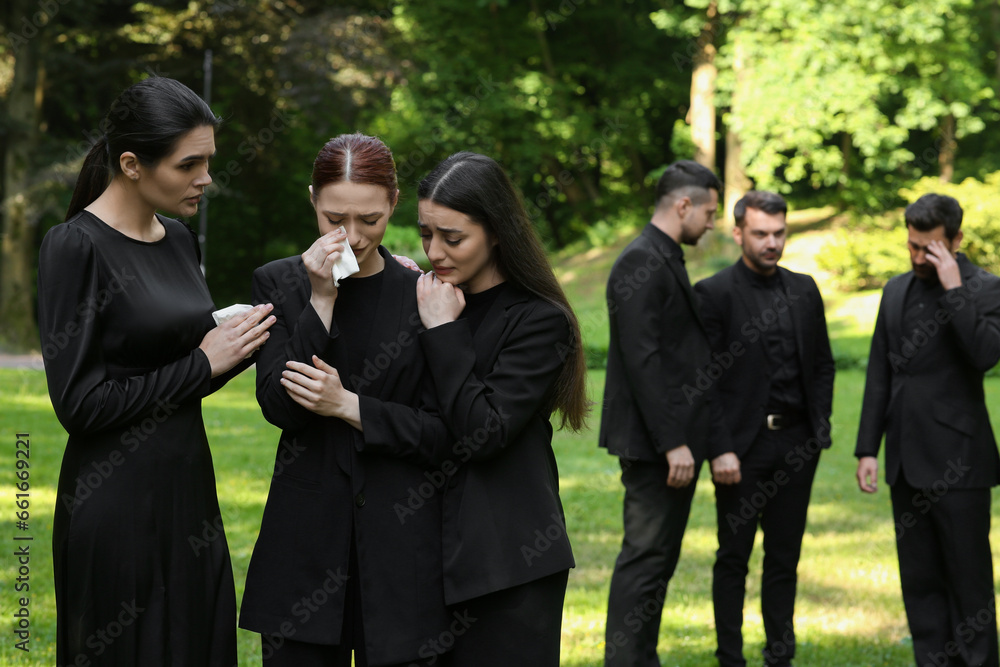 Sad people in black clothes mourning outdoors. Funeral ceremony Sad people in black clothes mourning outdoors. Funeral ceremony