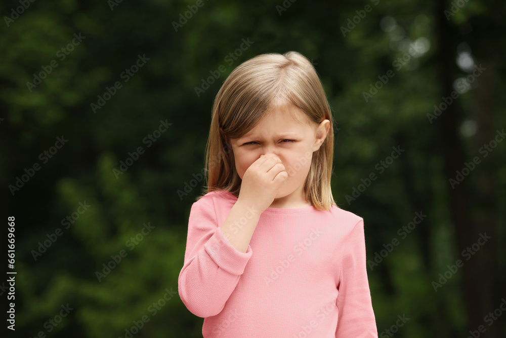 Little girl suffering from seasonal spring allergy outdoors Little girl suffering from seasonal spring allergy outdoors