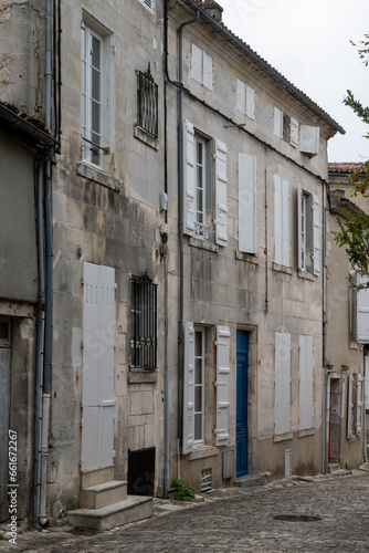 View on old streets and houses in Cognac white wine region, Charente, walking in town Cognac with strong spirits distillation industry, France © barmalini