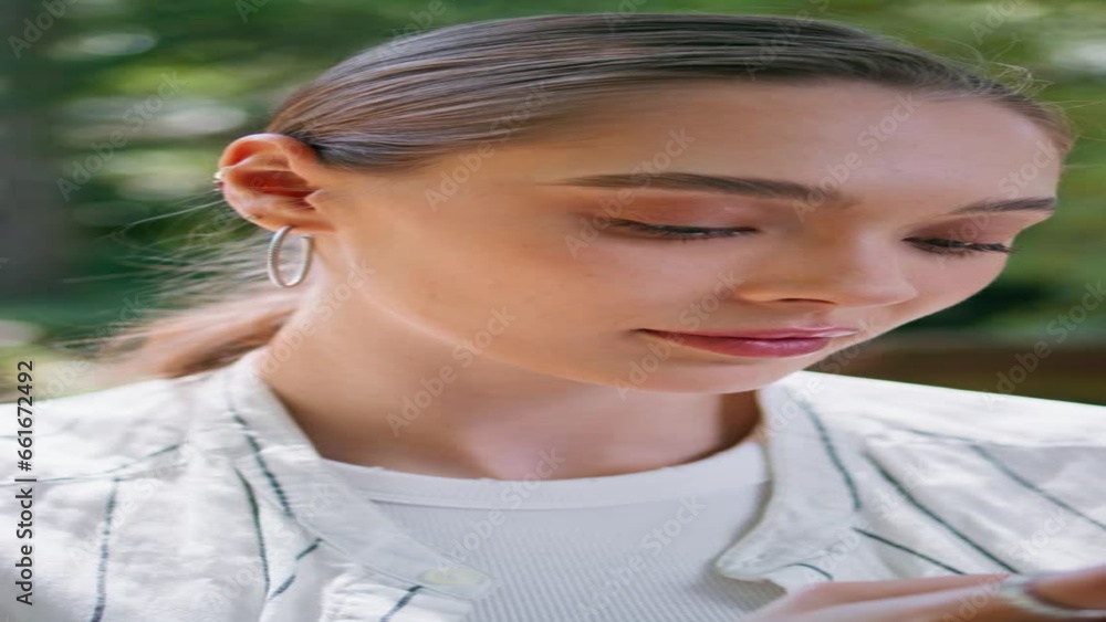 Closeup woman looking smartphone at nature. Girl choosing purchases vertical Closeup woman looking smartphone at nature. Girl choosing purchases vertical