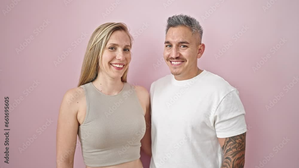 Man and woman couple hugging each other kissing over isolated pink background Man and woman couple hugging each other kissing over isolated pink background