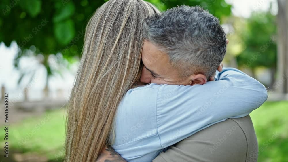Man and woman couple hugging each other smiling at park Man and woman couple hugging each other smiling at park