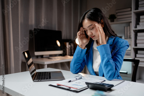 Asian women are stressed and tired from long hours of work, and businesswomen work hard causing office syndrome that often occurs in working people. The concept of office syndrome.