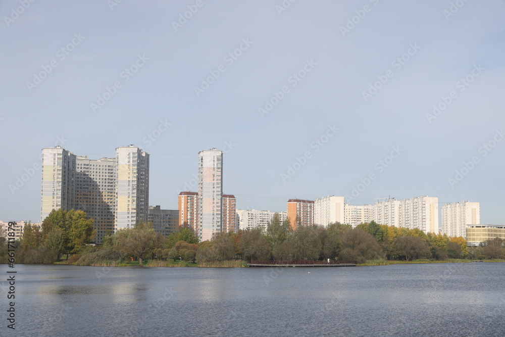 View of residential buildings on the shore of a pond in a landscape park, Yuzhnoye Butovo, Moscow, October 2023. View of residential buildings on the shore of a pond in a landscape park, Yuzhnoye Butovo, Moscow, October 2023.