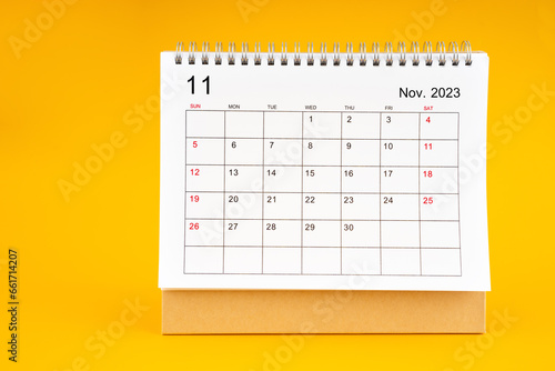 The November 2023, Monthly desk calendar for 2023 year on yellow color background. © gamjai