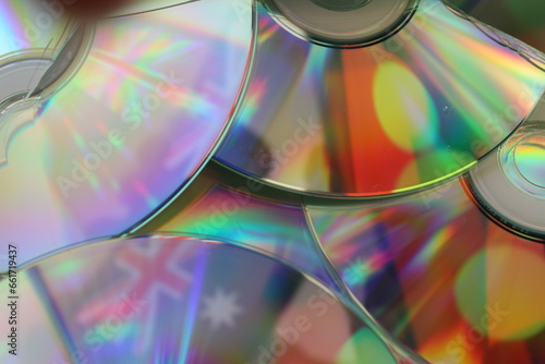 The Australian and Aboriginal flags reflected in a number of broken compact discs representing the fractured relationship between white and black Australia. 