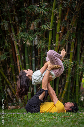 Acroyoga Lunar therapy, Thai massage, couple massage, outdoors, with bamboo background