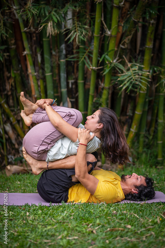 Acroyoga Lunar therapy, Thai massage, couple massage, outdoors, with bamboo background