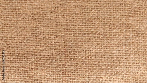 Hessian sackcloth burlap woven texture background, Cotton woven fabric close up with flecks of varying colors of beige and brown, with copy space for text decoration. Burlap texture