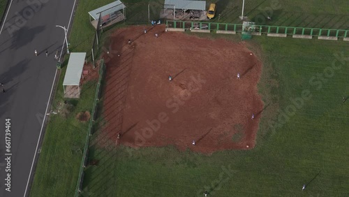 Aerial footage of baseball team training in the infield at Bali Shisanhang Cultural Park, Indonesia photo
