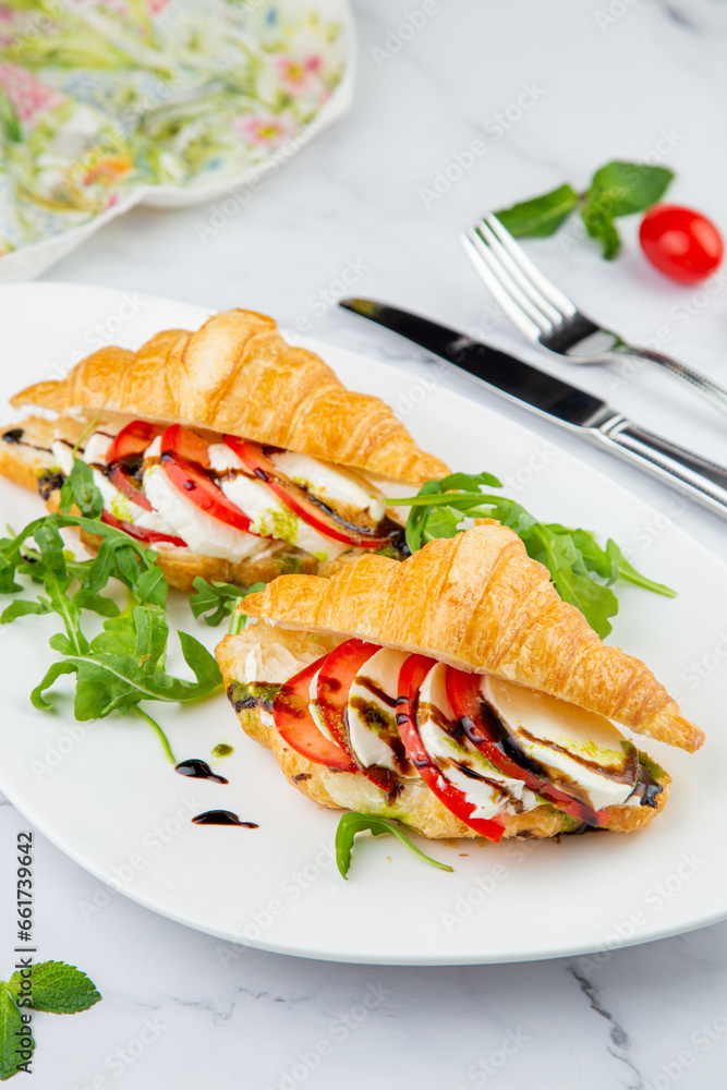 croissants with cheese, vegetables, cherry tomatoes and herbs