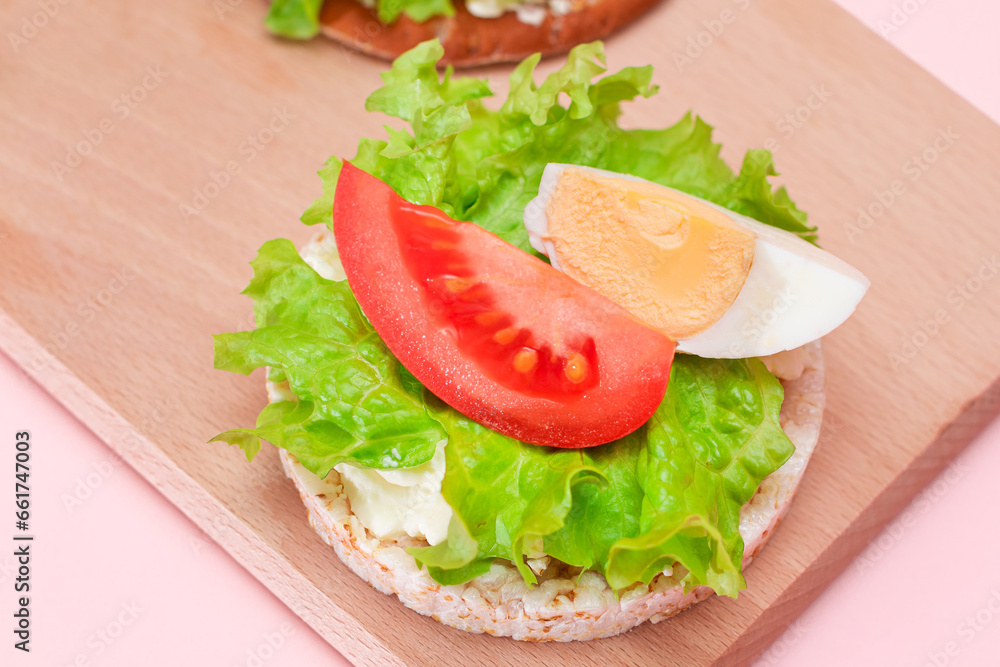 Rice Cake Sandwiches with Tomato, Lettuce and Egg on Wooden Cutting Board. Easy Breakfast. Diet Food. Quick and Healthy Sandwiches. Crispbread with Tasty Filling. Healthy Dietary Snack