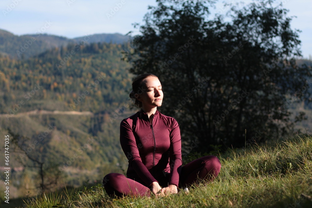 woman practices yoga outdoor in mountain landscape woman practices yoga outdoor in mountain landscape