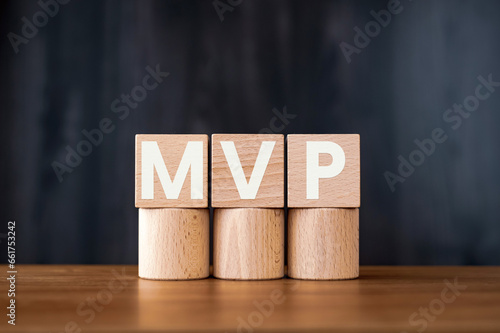 There is wood cube with the word MVP. It is an abbreviation for Minimum Viable Product as eye-catching image.