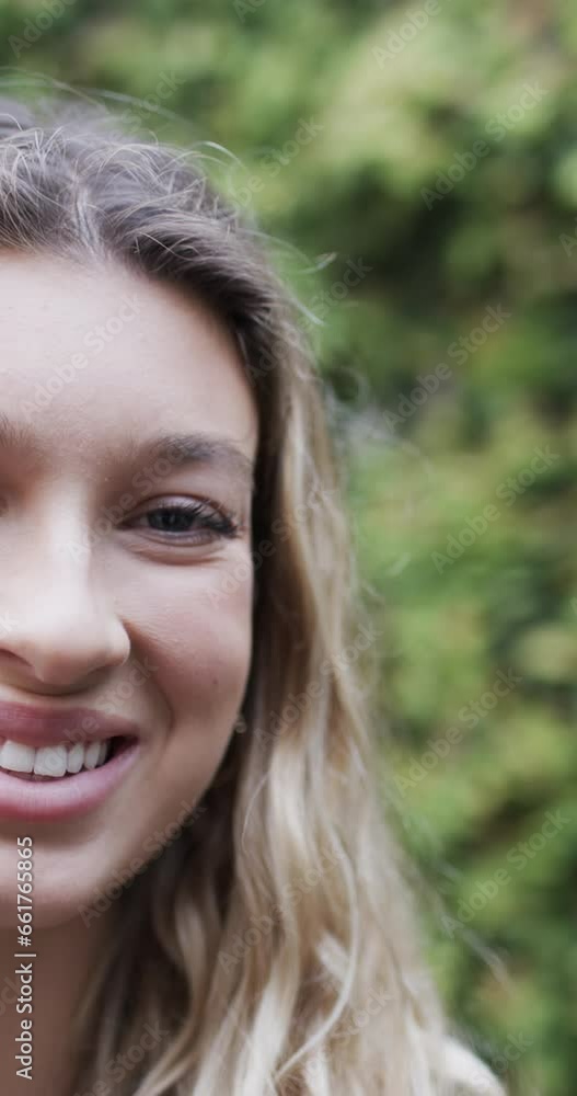 Vertical video of portrait of happy biracial woman smiling in garden, slow motion, copy space Vertical video of portrait of happy biracial woman smiling in garden, slow motion, copy space