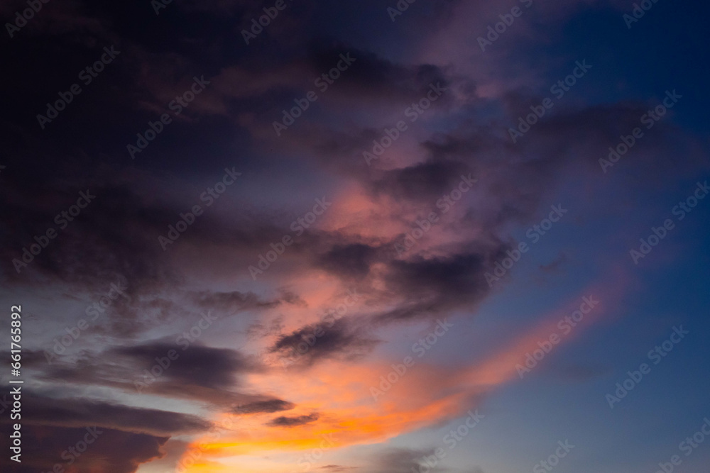 twilight sky with sun beam in evening time.  dark cloud with