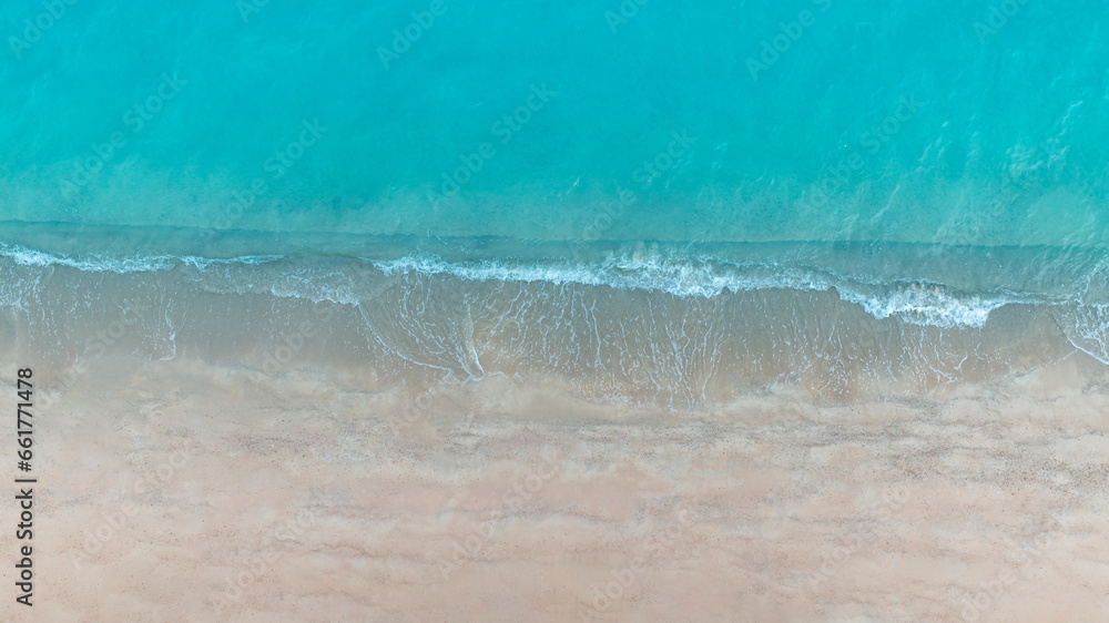 Beach Wave water in the Tropical summer beach with  sandy beach background