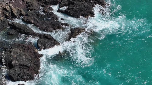 Aerial coastal rocky shore beautiful waves Kona Hawaii. Big Island, largest, most volcanic active destination. Economy is tourism. Beautiful clear blue ocean sea. Rocky cliff. Waves and surf. photo