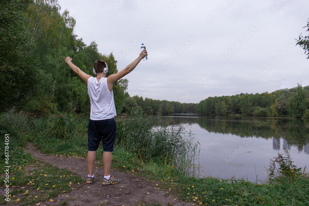 The athlete is resting in nature after training, running The athlete is resting in nature after training, running