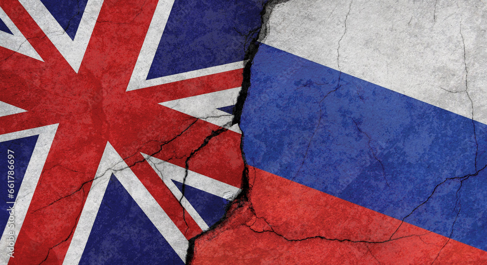 Fototapeta premium UK and Russian flags, cracked concrete wall texture, grunge background, military conflict concept