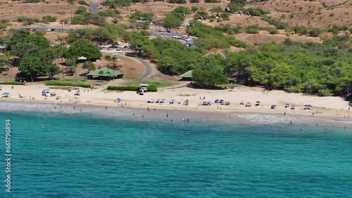 Aerial coastal public beach Kona Hawaii pan. Big Island. Economy is tourism based. Volcanic lava rock, black sand and white sand beach. Water tropical beach recreation and fun. photo