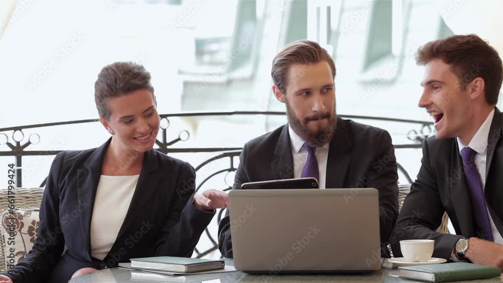 Businesspeople sitting at restaurant table and talking Businesspeople sitting at restaurant table and talking