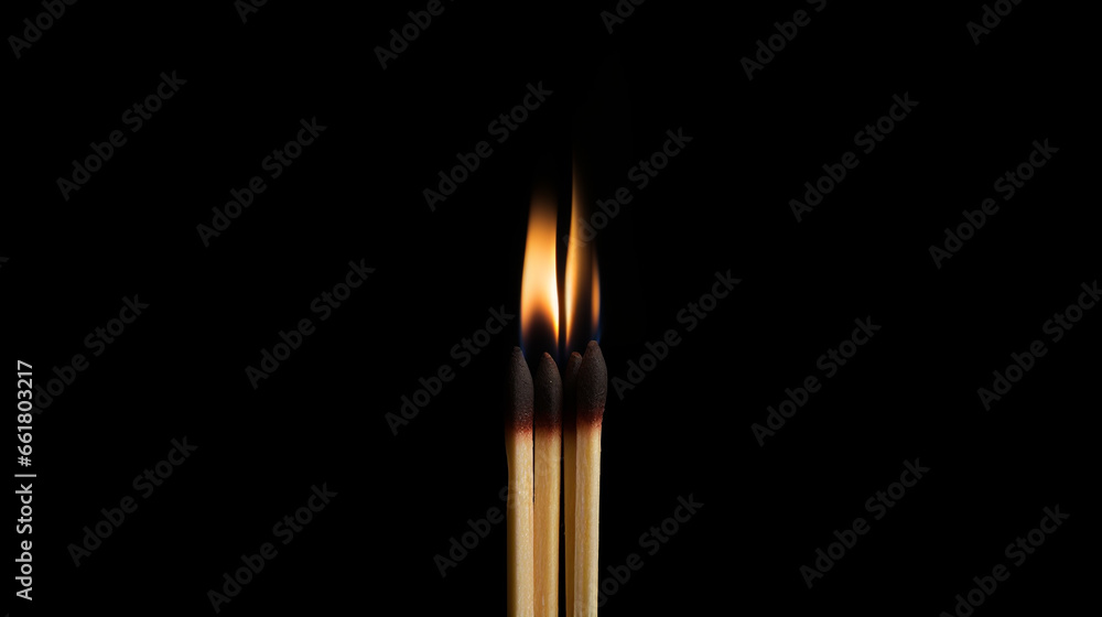 three matches burning on a black background close-up three matches burning on a black background close-up