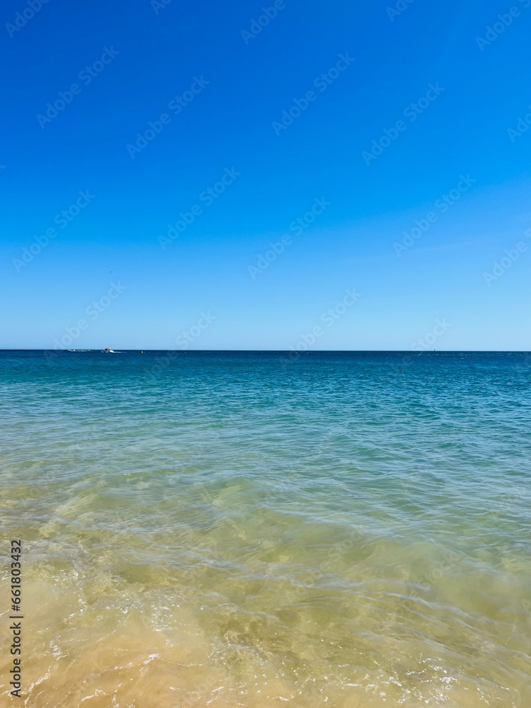 Blue sea horizon, transparent sea surface with ripples, clear blue sea and blue sky