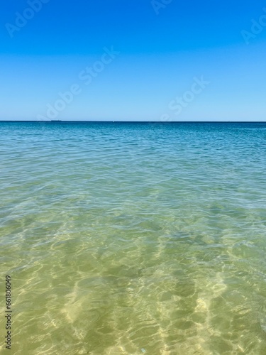 Blue sea horizon, transparent sea surface with ripples, clear blue sea and blue sky