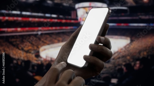 Photography CU African-American Black male using phone during ice hockey game