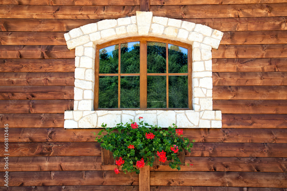 Window with flowers on a wooden wall Window with flowers on a wooden wall