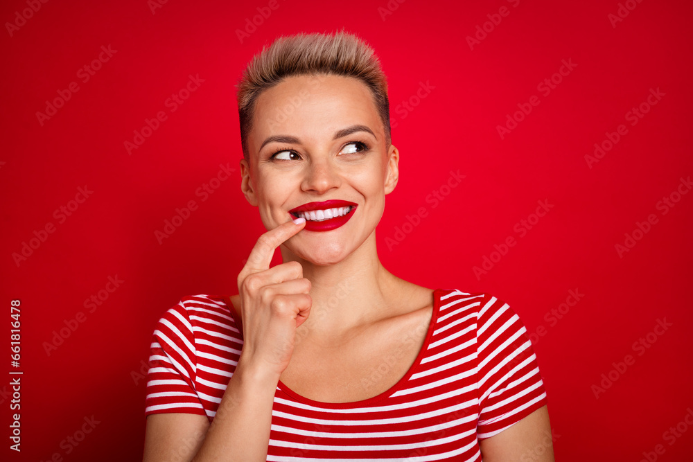 Photo of young beautiful lady touch her teeth thinking and dreaming about new hairstyle look empty space isolated on red color background Photo of young beautiful lady touch her teeth thinking and dreaming about new hairstyle look empty space isolated on red color background