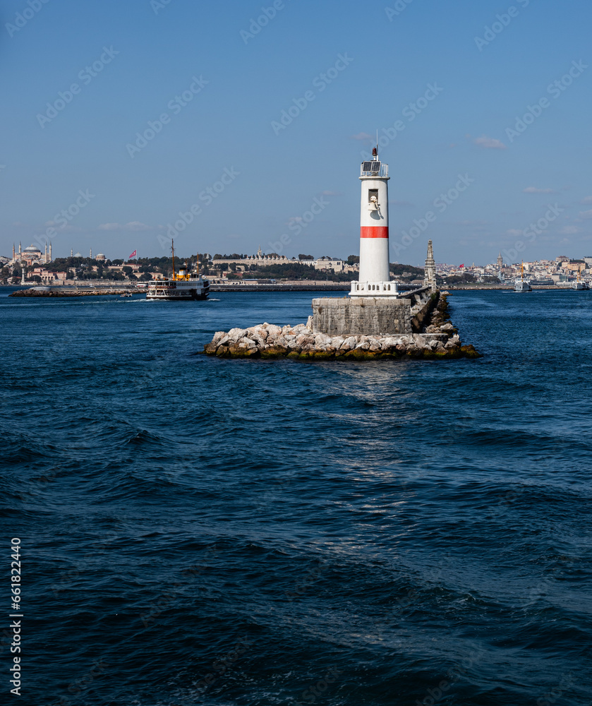 white lighthouse with red line in the sea, Istanbul