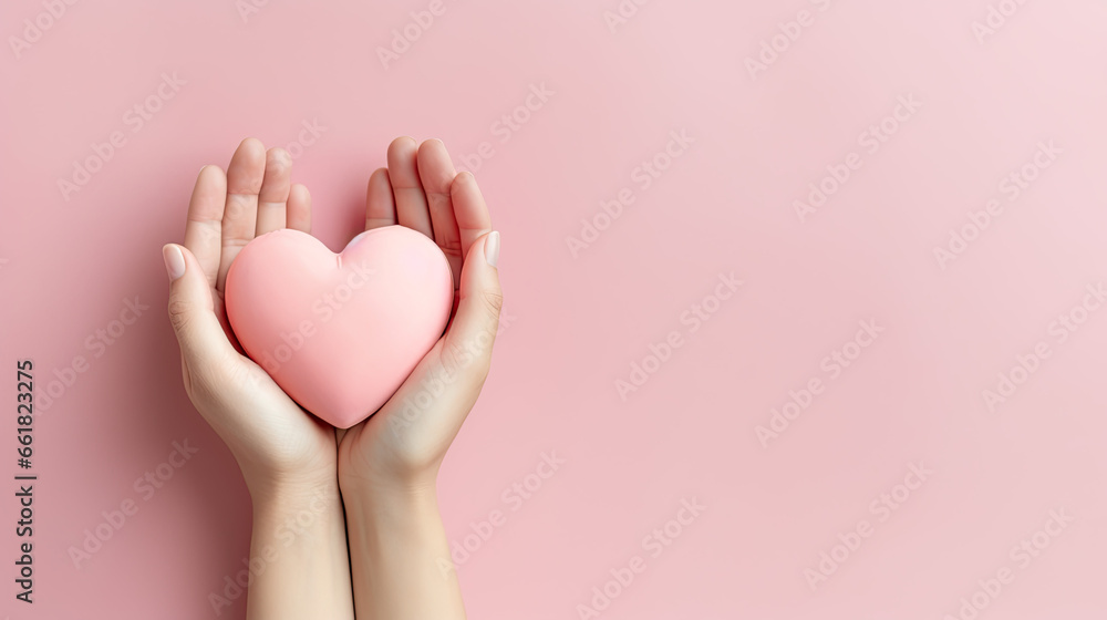 Woman's hands holding pink heart on a light pink background, Valentine's Day background Woman's hands holding pink heart on a light pink background, Valentine's Day background
