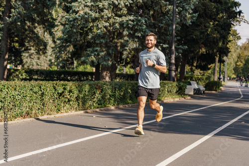 Training development of the cardiac system. Warm-up runner happy uses sportswear. A hardy young man exercises alone. Slim body and active lifestyle.