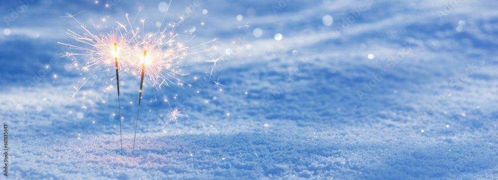 two burning sparklers in snow, party together concept banner background with copy space for happy new year or merry christmas or other festive holiday events - obrazy, fototapety, plakaty 