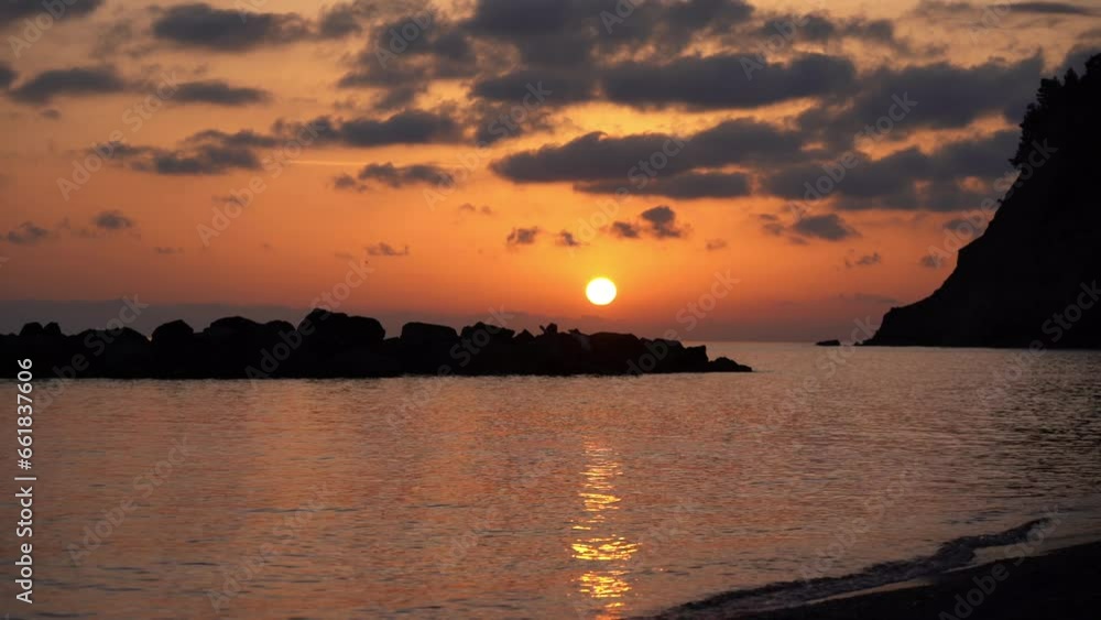Amazing sunset by the sea - beach and orange sun with clouds - Caribbean color of the nature in seaside landscape - summer and holidays travel Amazing sunset by the sea - beach and orange sun with clouds - Caribbean color of the nature in seaside landscape - summer and holidays travel