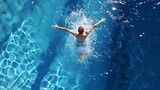 A man swimming with his arms outstretched in a pool