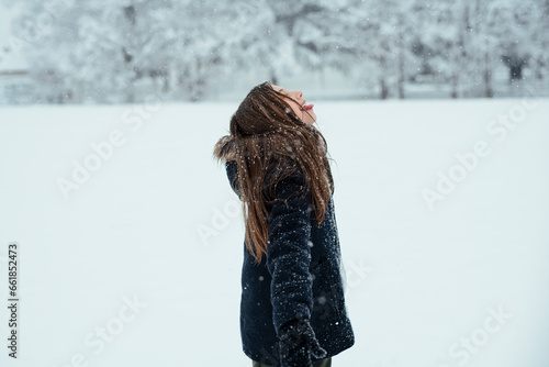 Happy little girl has fun in the winter forest.  Winter's fun concept. 